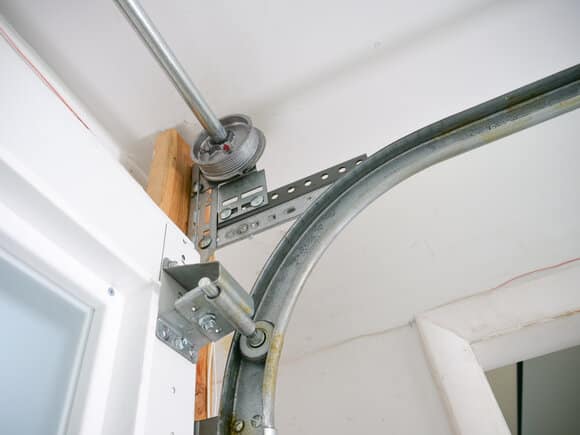 how to put garage door back on track